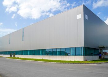 Ubicado en el dinámico sector industrial de México, se encuentra este imponente almacén premium de arquitectura contemporánea. La edificación destaca por su fachada de elegante revestimiento metálico gris y ventanas con cristal tintado en azul, proyectando una imagen sofisticada y moderna. Rodeado de vialidades pavimentadas y áreas verdes cuidadosamente diseñadas, este inmueble representa una oportunidad estratégica para inversionistas o compradores que buscan maximizar su portafolio en espacios industriales de alto nivel.